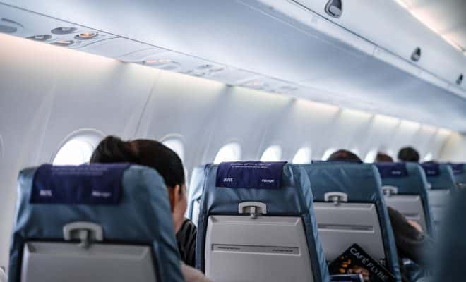 people sitting on gray and white airplane seats